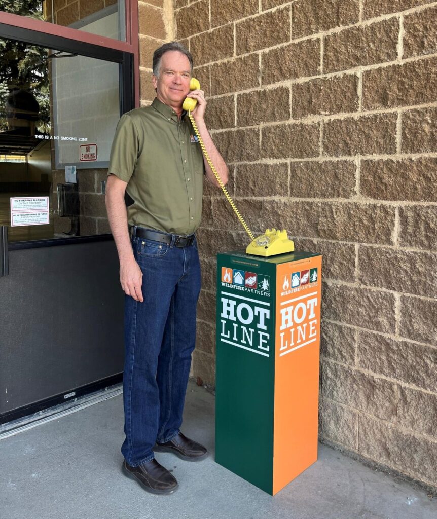 Wildfire Partner staff member using Hotline experiential telephone installation